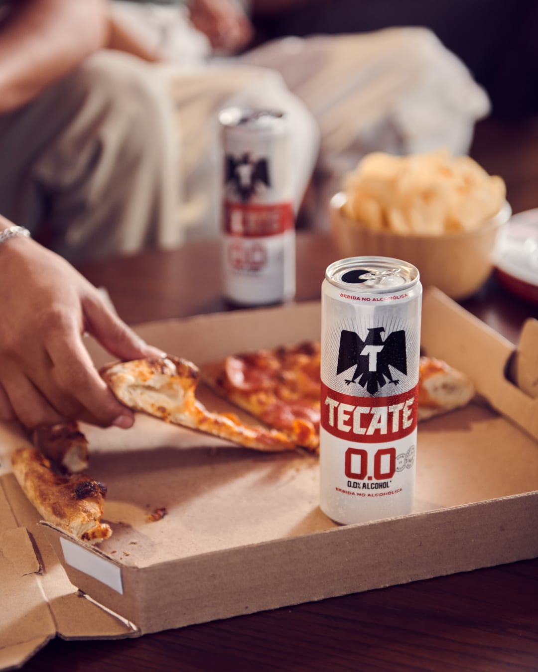 Tecate 00 beer can and pizza slices